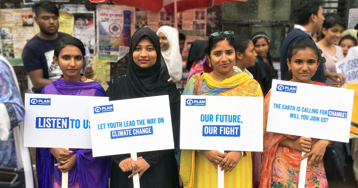 Women holding climate signs