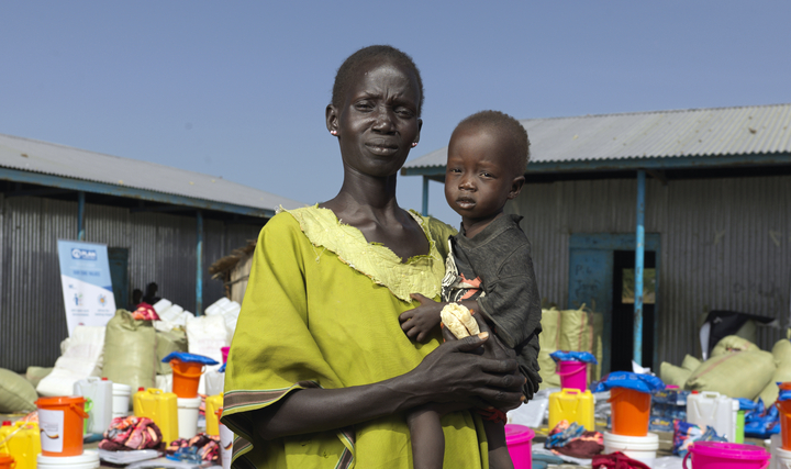 Mother in yellow robe holding child