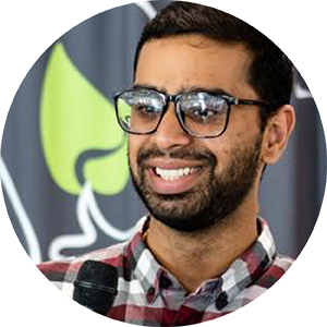 Picture of a young man with glasses smiling