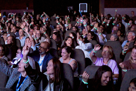 Audience Members Raise Glowing International Day of the Girl Bracelets