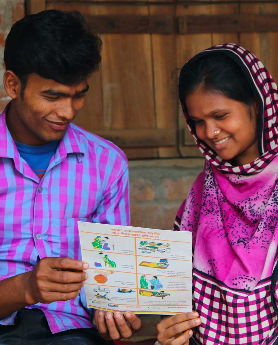 Bangladeshi couple read health pamphlet