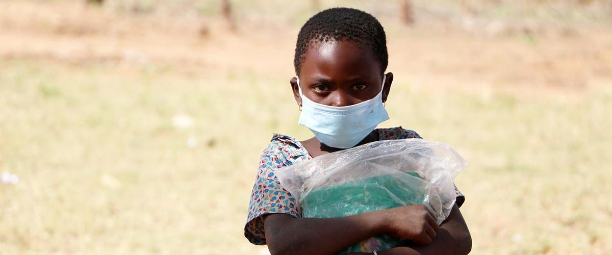 Girl in Cabo Delgado receives school supplies from Plan International