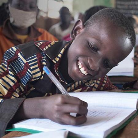 Boy writing in book