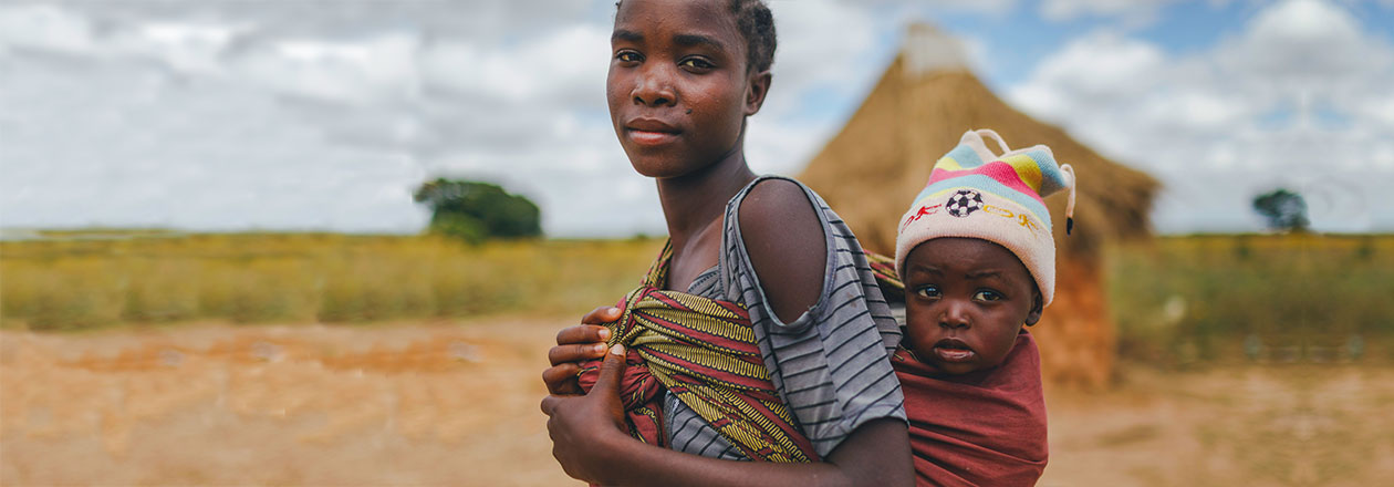 Girl carrying child
