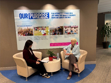 Plan International Canada CEO, Lindsay Glassco sits with a young woman and member of Girls Belong Here