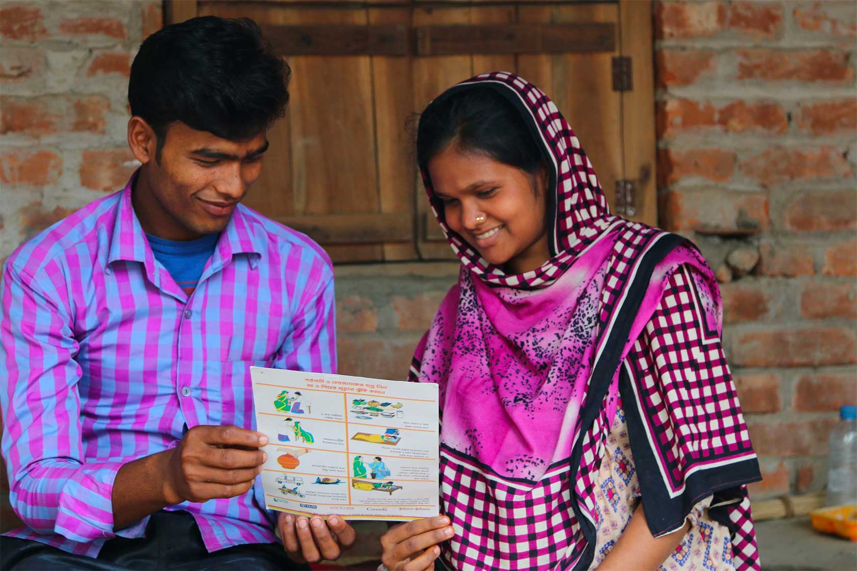 Bangladeshi couple read health pamphlet