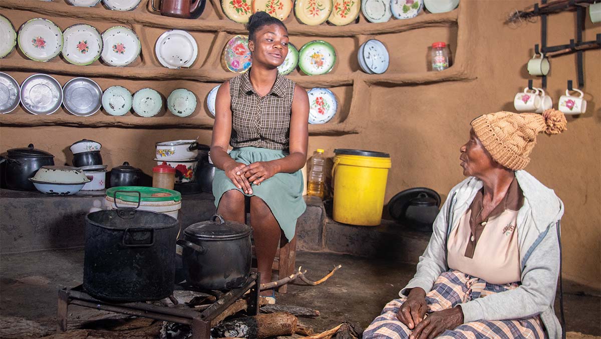 Tanyaradzwa prepares the evening meal with her grandmother in their home.