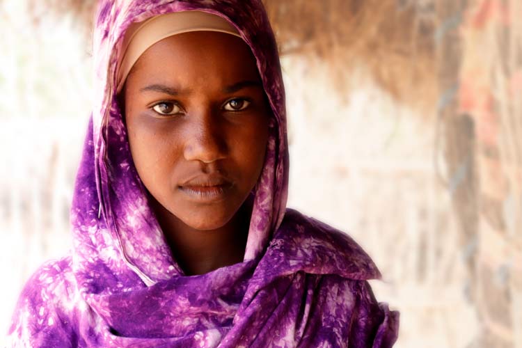 Nasra walks 24 kilometres before and after school to fetch water for her family.