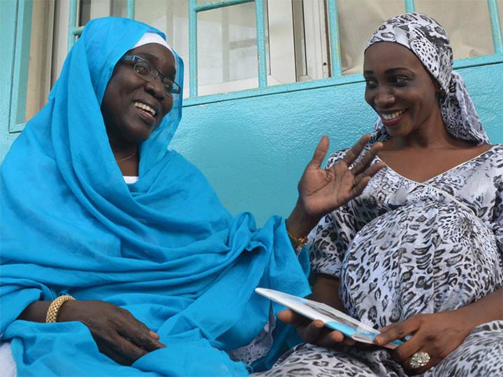 A pregnant woman has a consultation with a health care worker in Senegal.