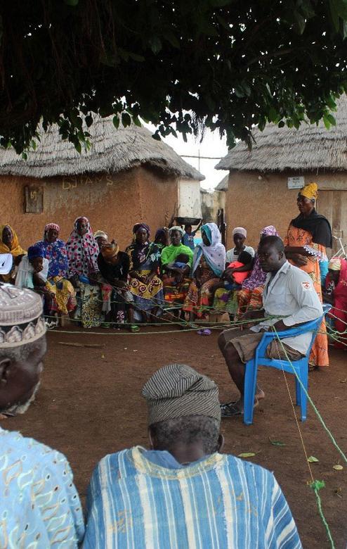 A field officer conducts training with support of community-based volunteers