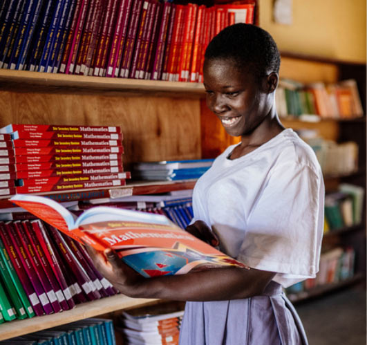 Girl reading book in library