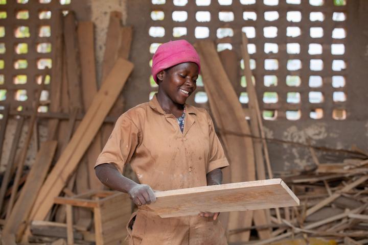 Claudine, 21, cuts wood down to size in carpentry workshop