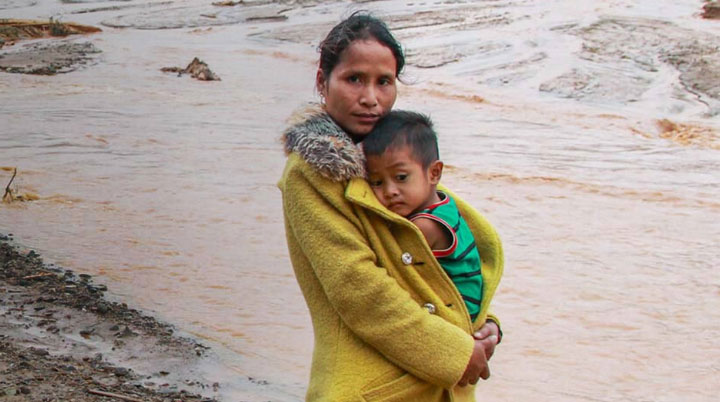 Woman holding child at refugee camp