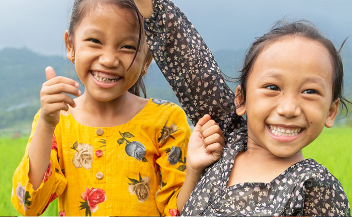 Two children waving