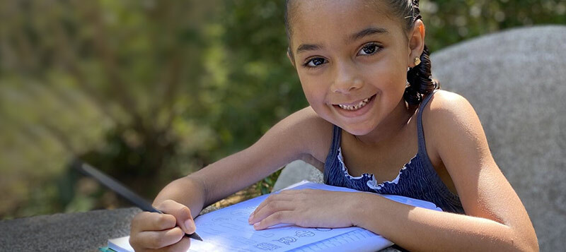 Girl writing in schoolbook