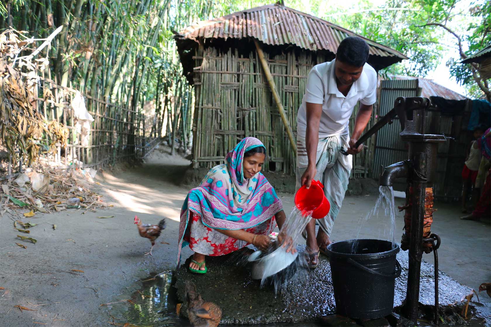 Husband helping wife get water