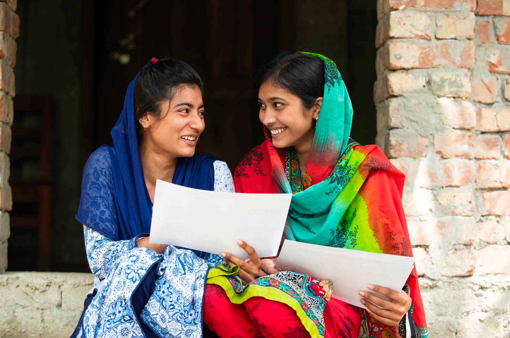 Two girls sitting in doorway