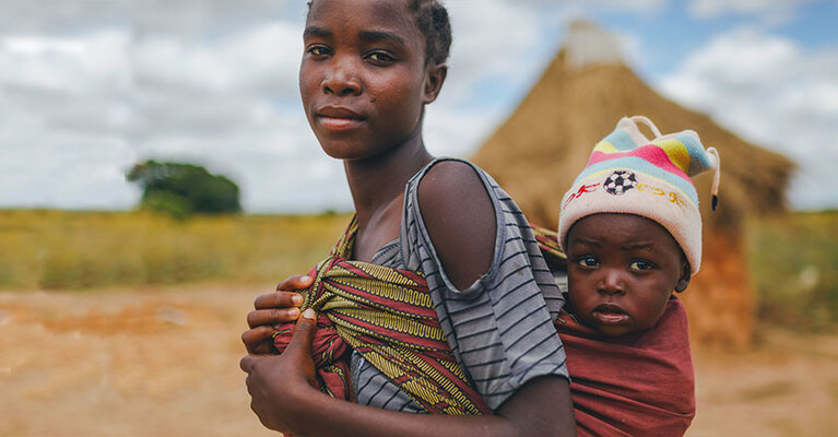 Girl carrying child
