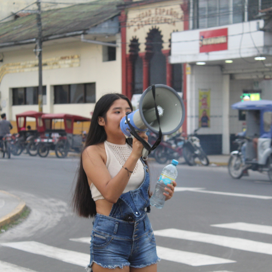 An adolescent girl holding a megaphone