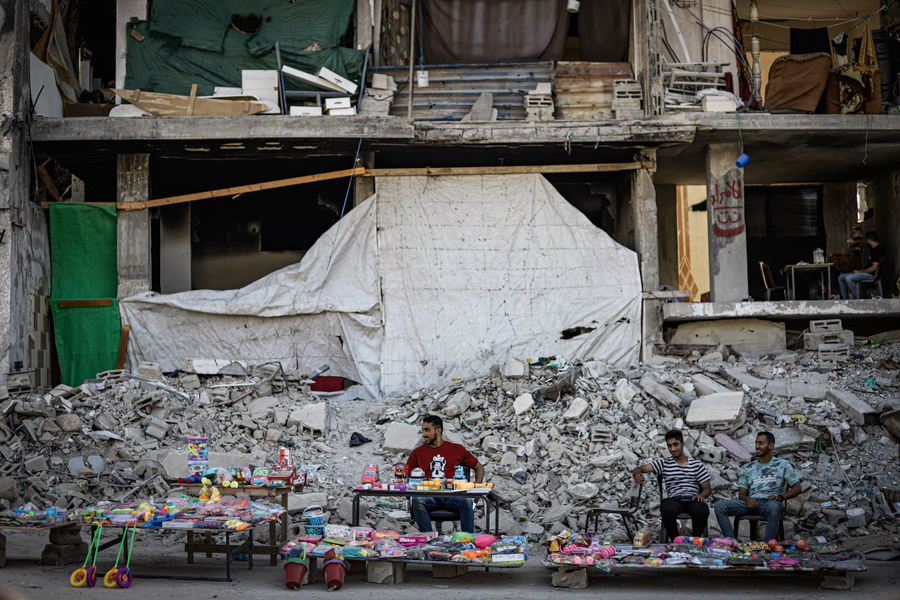 A toy stall outside a building destroyed by bombing in Gaza