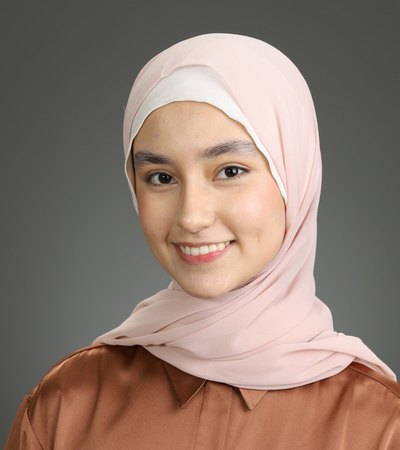 A professional headshot of a woman wearing a black collared shirt.