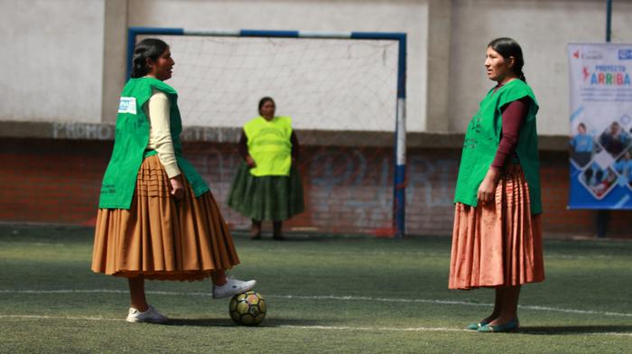 two girls playing football