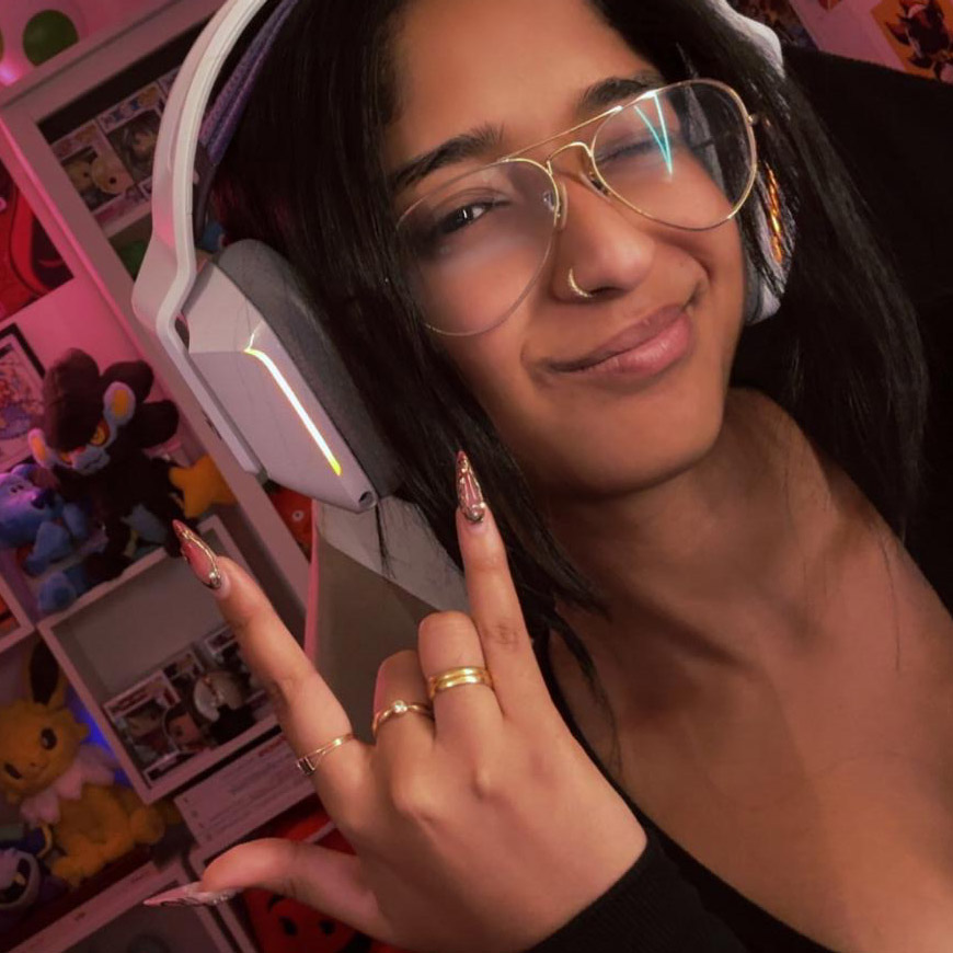  Girl smiling as she livestreams on the computer with headphones on