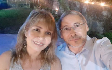 One photo of a man and a woman on a date with bright lights behind them