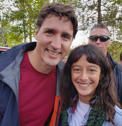 A girl smiles next to a man  . 