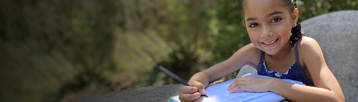 Girl writing in schoolbook