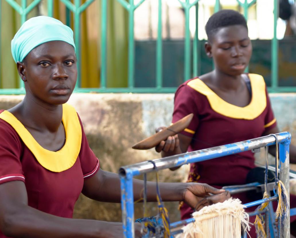 Hafsaf (left), 21, weaves cloth  that will be sold at the local market