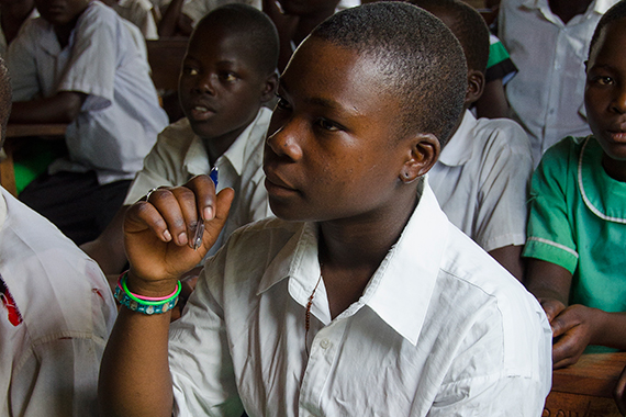 A young girl sits focused in class