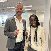 Two colleagues smiling together in an office