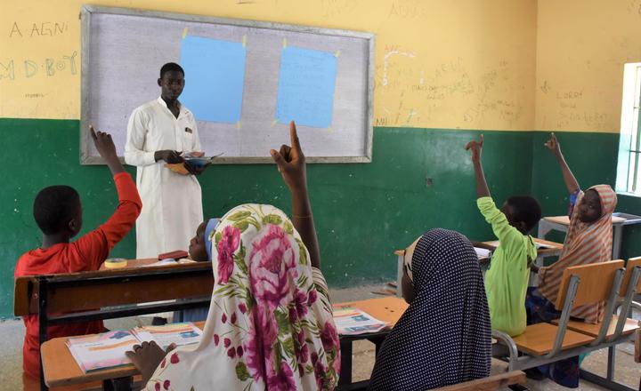 Ali Ibrahim teaches children at the accelerated learning centre in Borno