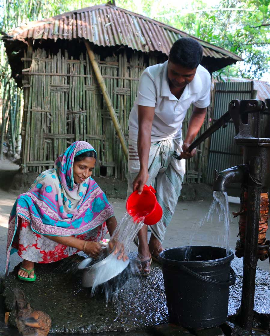 Husband helping wife get water