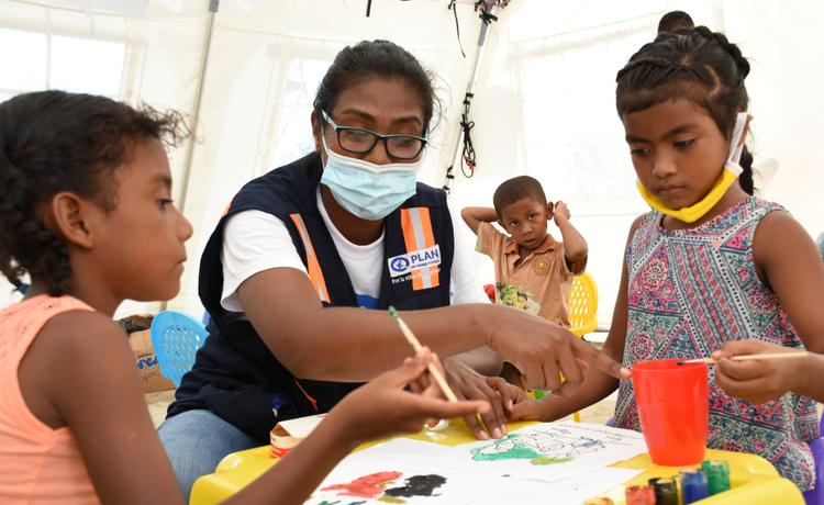 Children paint pictures in a Plan International child-friendly safe space established following a hurricane in Nicaragua.