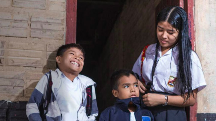 Young girl with brother and sister