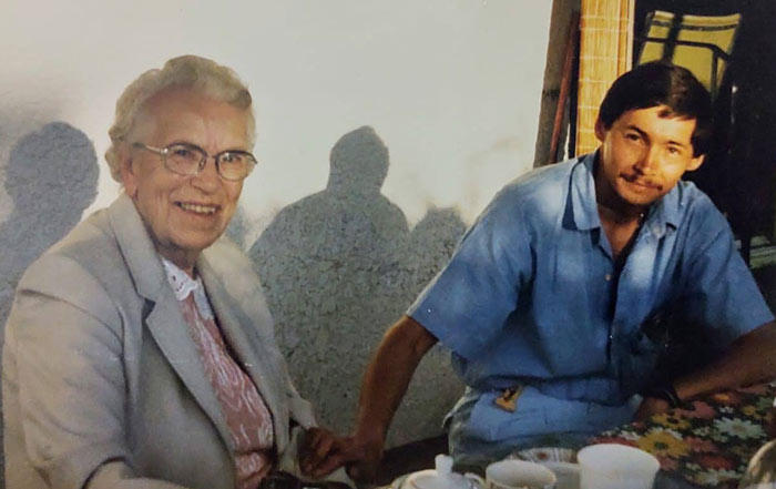 Two old photographs of a young man and an older woman beside each other