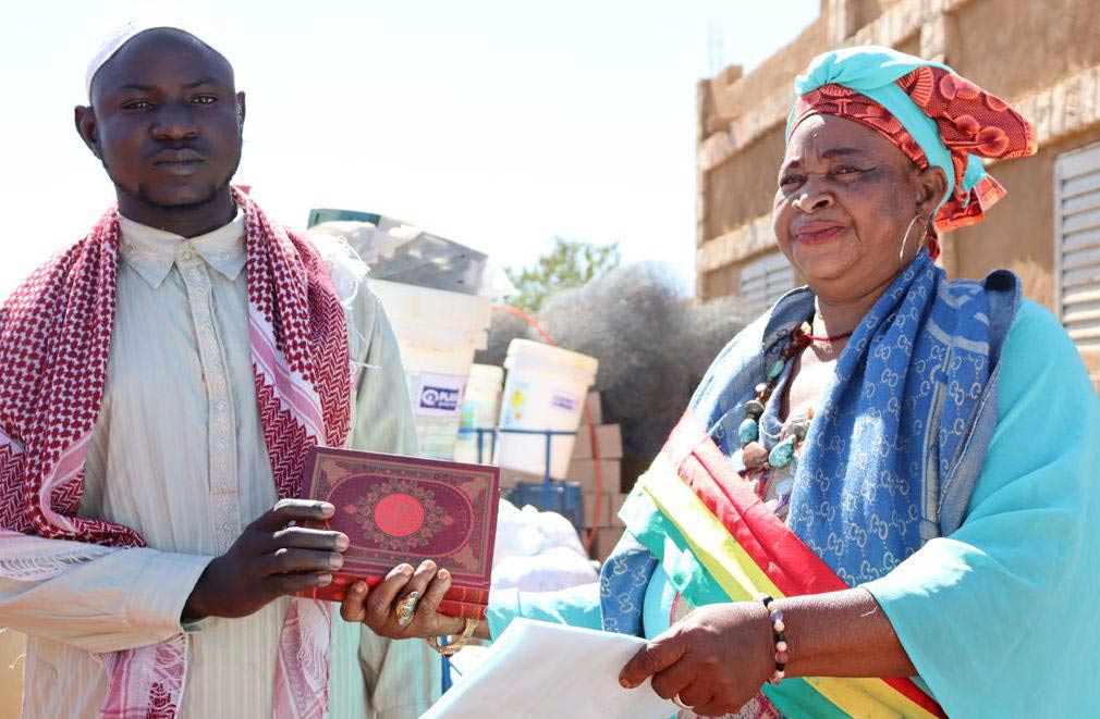 The Mayor of Bandiagara, right, delivers school supplies provided by Plan International to local Quranic schools.