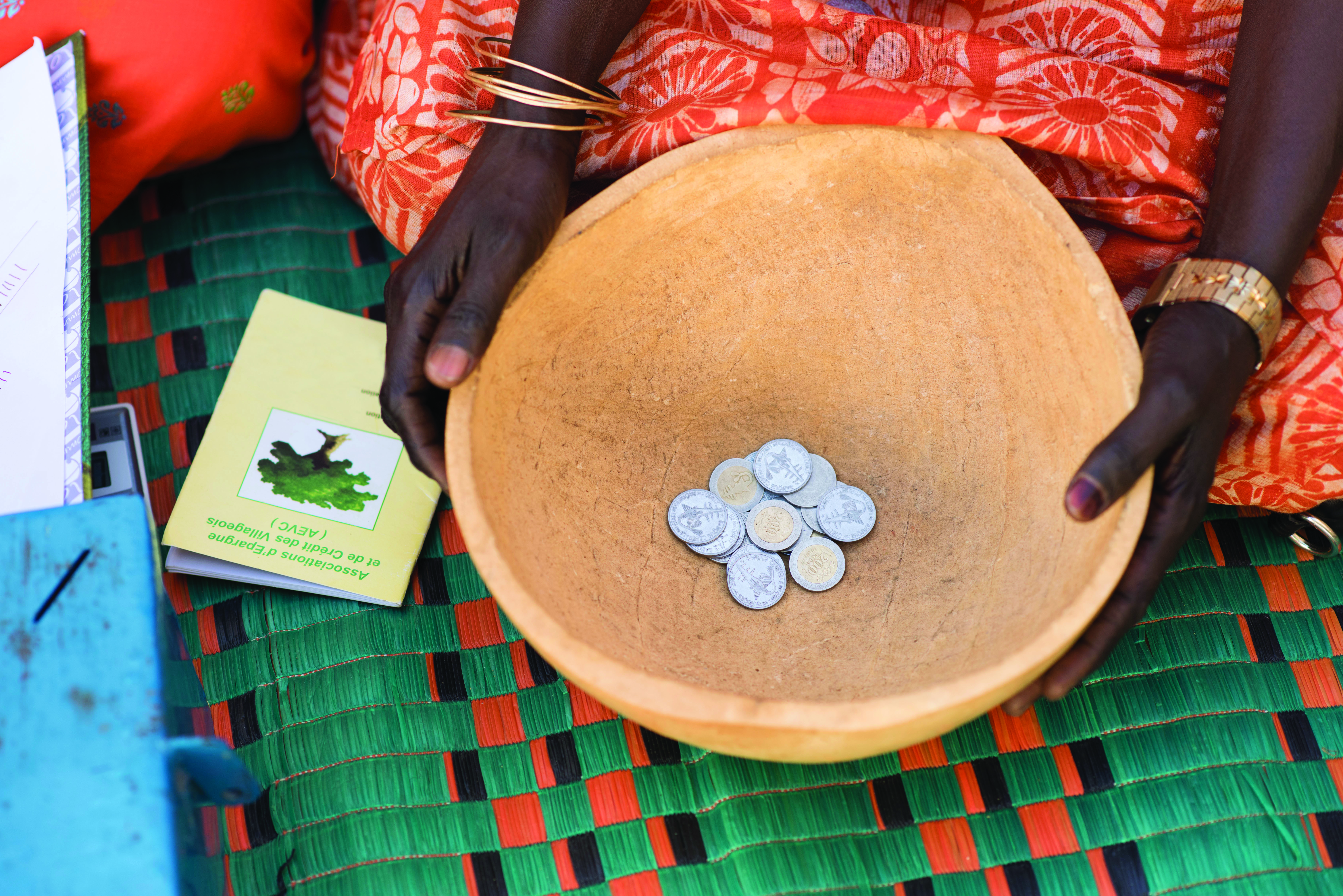 SHOW Village Savings and Loans project, close up of coins in a bowl on the ground  