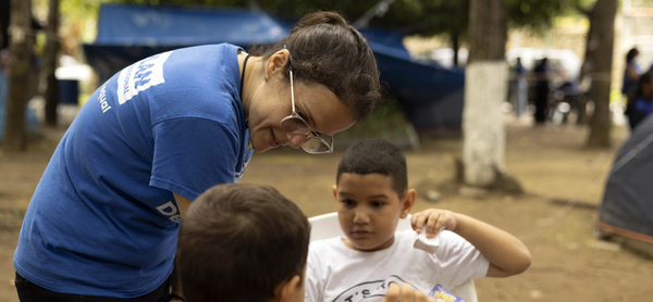  Two young advocates pictured side by side – one outdoors on a city street and the other during an event.