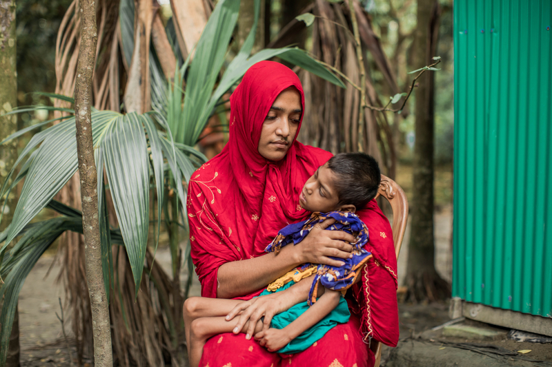 A woman holding her child.
