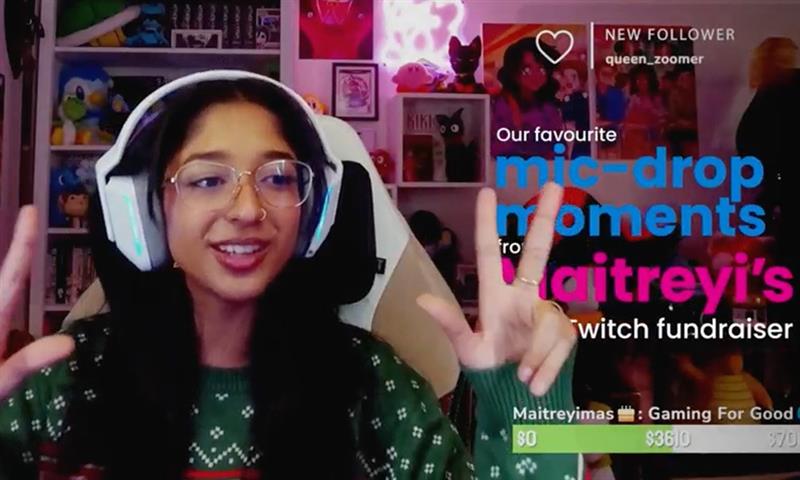 Girl smiling as she livestreams on the computer with headphones on