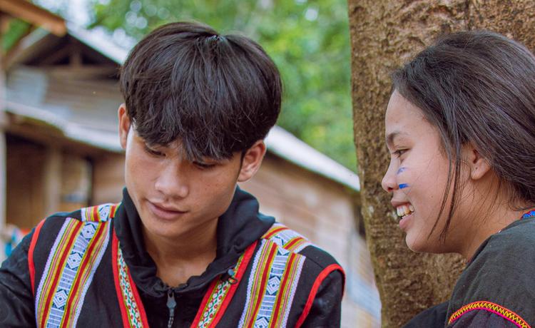  A teen boy and girl read through a Life Skills Training for Girls manual. Boys and girls alike are working together to end forced marriage in Vietnam. 