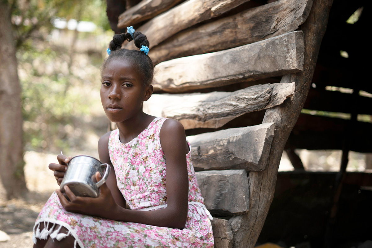 A young girl sitting down