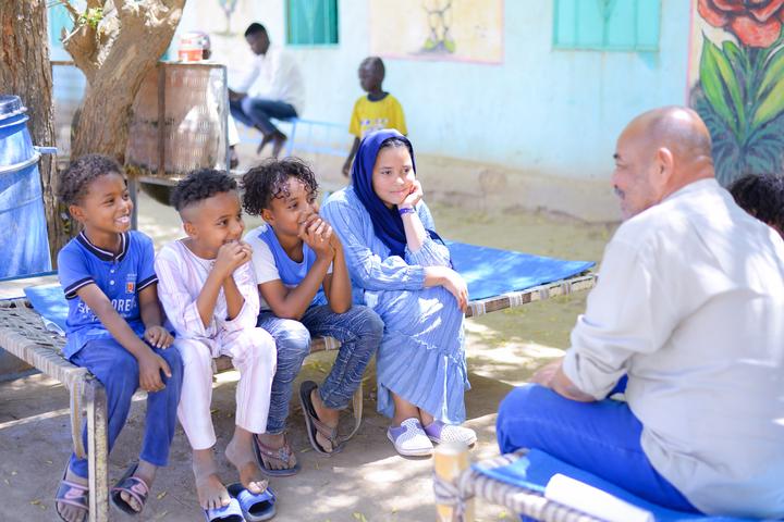 Angham, 14, and her four younger brothers chat to their father Nabeel