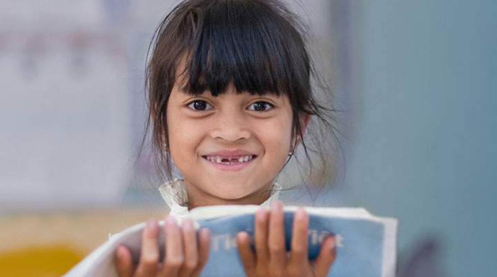 Girl with backpack smiles
