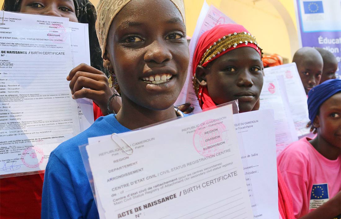 Girls show their new birth certificates