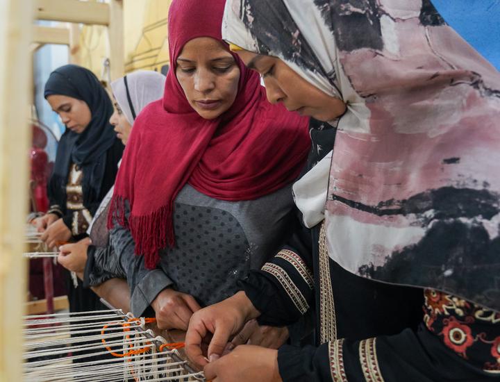 Iman Said, 36, one of the top Kilim trainees , showing another women how to work on a carpet