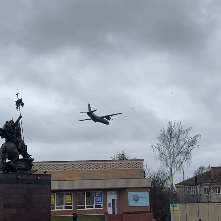 A building with a plane flying overhead